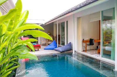 a house with a swimming pool in front of a house at White Villa in Seminyak