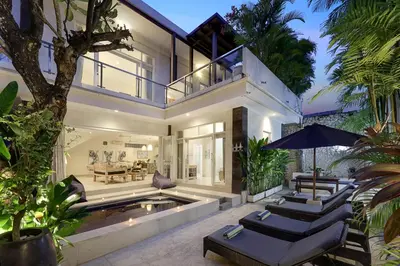 an exterior view of a house with a swimming pool at Villa Alba in Seminyak