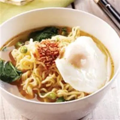 a bowl of noodles with a fried egg on top at The Rani Garden Bed & Breakfast in Denpasar