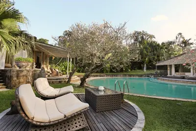 a backyard with a pool and a table and chairs at Maya Villa - Seminyak in Seminyak