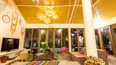 a living room with a couch and a tv at Luxury Villa Kudeta 300m BEACH and heart of Seminyak in Seminyak