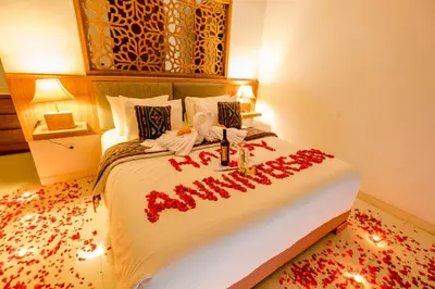 a bedroom with a large bed with red writing on it at Mahana Living in Denpasar