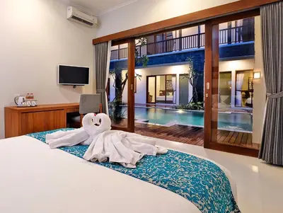 a bedroom with a bed with a towel animal on it at Mahana Living in Denpasar