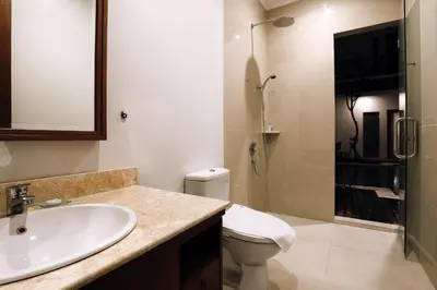 a bathroom with a sink and a toilet and a shower at Mahana Living in Denpasar