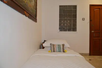 a bedroom with a bed with a pillow on it at Sofi Apartment at Jayakarta Residence in Legian