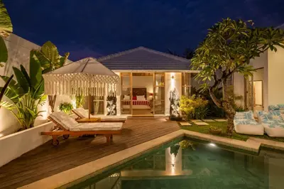 a villa with a swimming pool at night at Villa Dipta in Seminyak