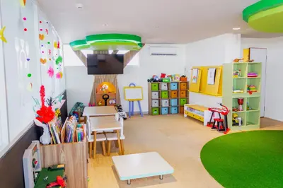a room with a classroom with a table and chairs at Tijili Hotel Benoa in Nusa Dua
