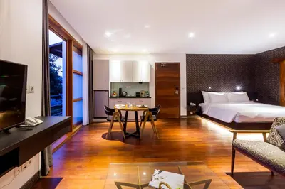 a hotel room with a bed and a table at Imani Suites in Seminyak