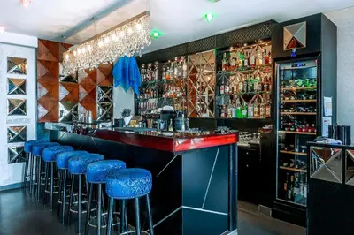 a bar with blue stools in a restaurant at Imani Suites in Seminyak