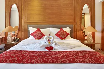 a bedroom with a bed with two swans on it at Royal Tulip Springhill Resort Jimbaran in Jimbaran