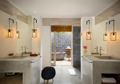 a bathroom with two sinks and a tub at Alea Estate in Kerobokan