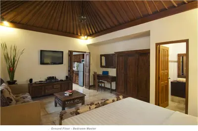 a living room with a bed and a couch at 2BR Villa Senin - Minggu Villas Seminyak in Seminyak