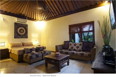 a living room with a bed and a couch and a table at 2BR Villa Senin - Minggu Villas Seminyak in Seminyak