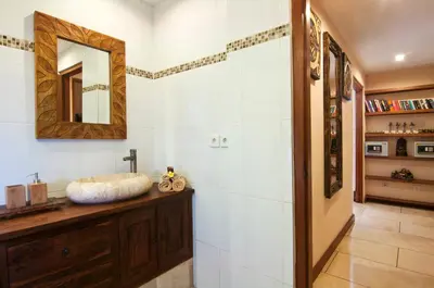 a bathroom with a sink and a mirror at 4BR Villa Selasa - Minggu Villas Seminyak in Seminyak