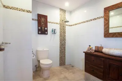 a bathroom with a toilet and a sink at 4BR Villa Selasa - Minggu Villas Seminyak in Seminyak