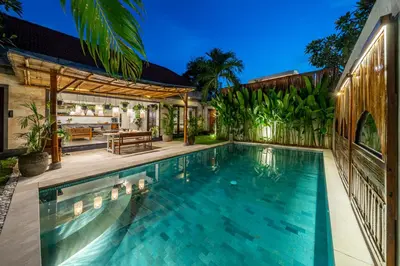 an outdoor swimming pool with a patio and a house at Villa Sarong 2 Chic 2BR Boho Villa Prime Central Location in Seminyak