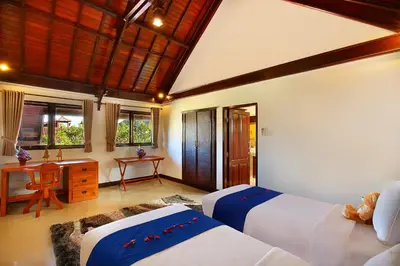 a bedroom with two beds and a desk at Alysha Villa Seminyak Beachside By Bali Asia Villa in Seminyak