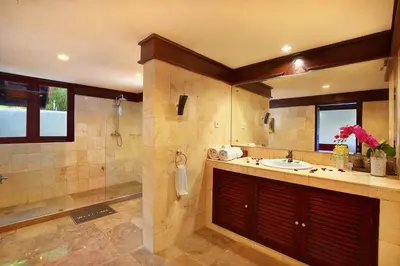 a large bathroom with a sink and a shower at Alysha Villa Seminyak Beachside By Bali Asia Villa in Seminyak