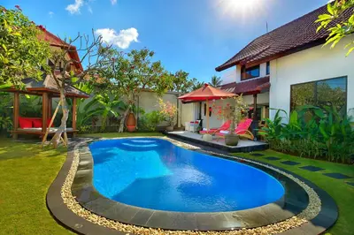 a swimming pool in the yard of a house at Alysha Villa Seminyak Beachside By Bali Asia Villa in Seminyak