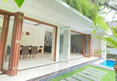 a villa with a swimming pool and a house at Kubu GWK Villa in Jimbaran