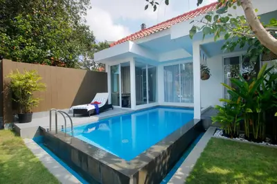 a swimming pool in the backyard of a house at Benoa Sea Suites and Villas in Nusa Dua