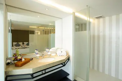 a bathroom with a sink and a mirror at Benoa Sea Suites and Villas in Nusa Dua