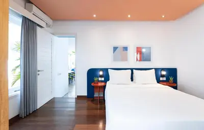 a bedroom with a large white bed and a window at Villa Ungava in Seminyak