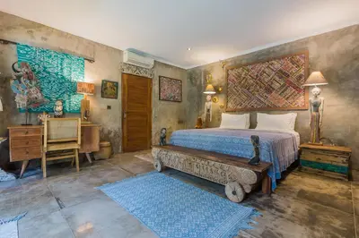 a bedroom with a bed and a desk and a bed sidx sidx sidx at Villa Kundalini in Seminyak