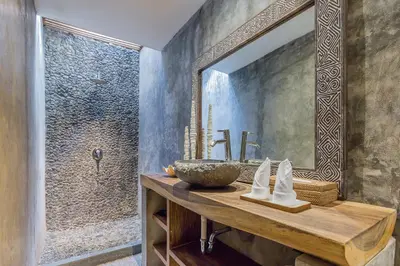a bathroom with a sink and a mirror at Villa Kundalini in Seminyak