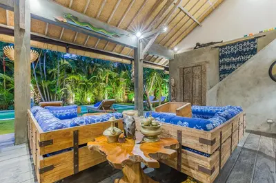 a living room with a couch and a table at Villa Kundalini in Seminyak