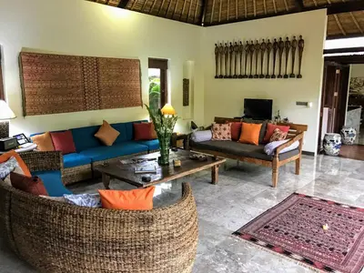 a living room with two couches and a tv at Bali Villa Aja in Seminyak