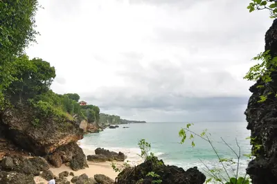 a view of the beach from a cliff at Kandava Villa in Jimbaran