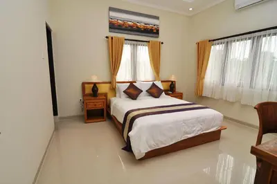 a bedroom with a king sized bed in a room at Kandava Villa in Jimbaran