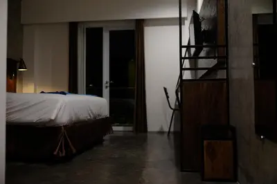 a bedroom with a bed and a television in it at Semimpi in Canggu