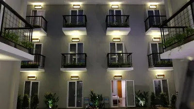 a facade of a building with balconies and lights at Semimpi in Canggu