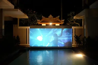 a large screen with a person on a stage at Semimpi in Canggu