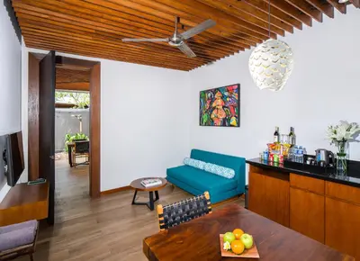 a living room with a blue couch and a table at S18 Bali Villas in Legian