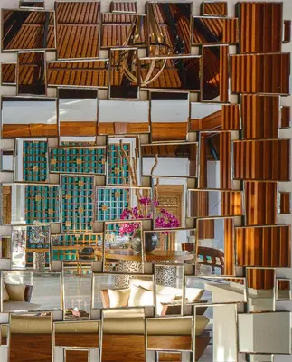 a lobby with chairs and a wall of books at S18 Bali Villas in Legian