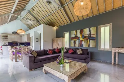 a living room with a couch and a table at VILLA Nuri Merah 1 in Kerobokan