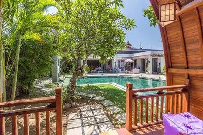 a view of the pool from the deck of a house at Villa Purple in Legian