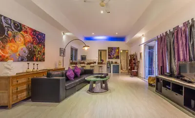 a living room with a couch and a table at Villa Purple in Legian