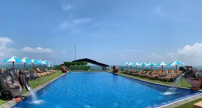 a swimming pool with two elephants in the water at Sulis Beach Hotel & Spa in Kuta