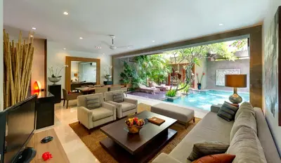 a living room with a couch and a table at Kanishka Villas in Seminyak