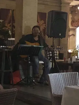 a man sitting in front of a microphone and a television at Bali Agung Village in Seminyak