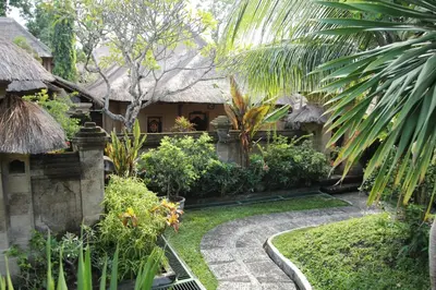 a garden with a house and a path at Bali Agung Village in Seminyak