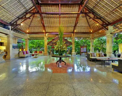 a lobby with a table in the middle of a building at Bali Agung Village in Seminyak