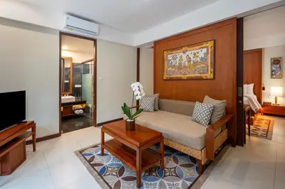 a living room with a couch and a tv at Kuta Seaview Beach Resort in Kuta