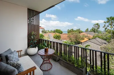 a balcony with a table and a view of the ocean at Kuta Seaview Beach Resort in Kuta