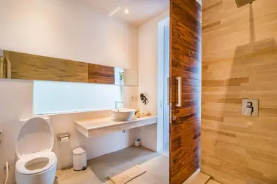 a bathroom with a toilet and a sink at Villa Kamag Seminyak in Seminyak