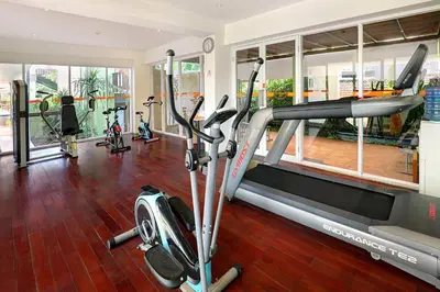 a gym with treadmills and elliptical machines at HARRIS Hotel Kuta Tuban Bali in Kuta